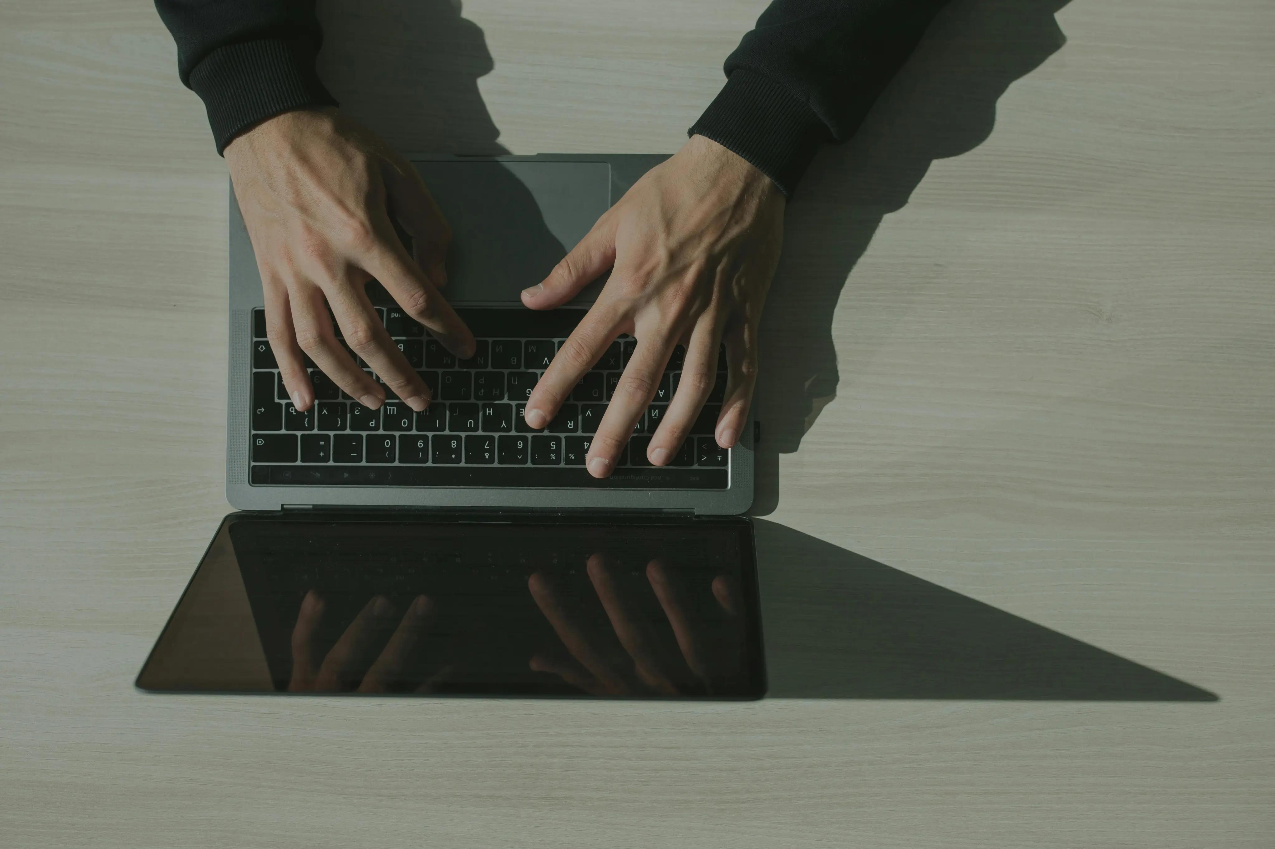 A person typing on a laptop