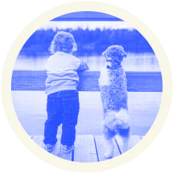 A small child and a puppy both looking at the landscape. This bond symbolizes trust, loyalty and companionship.