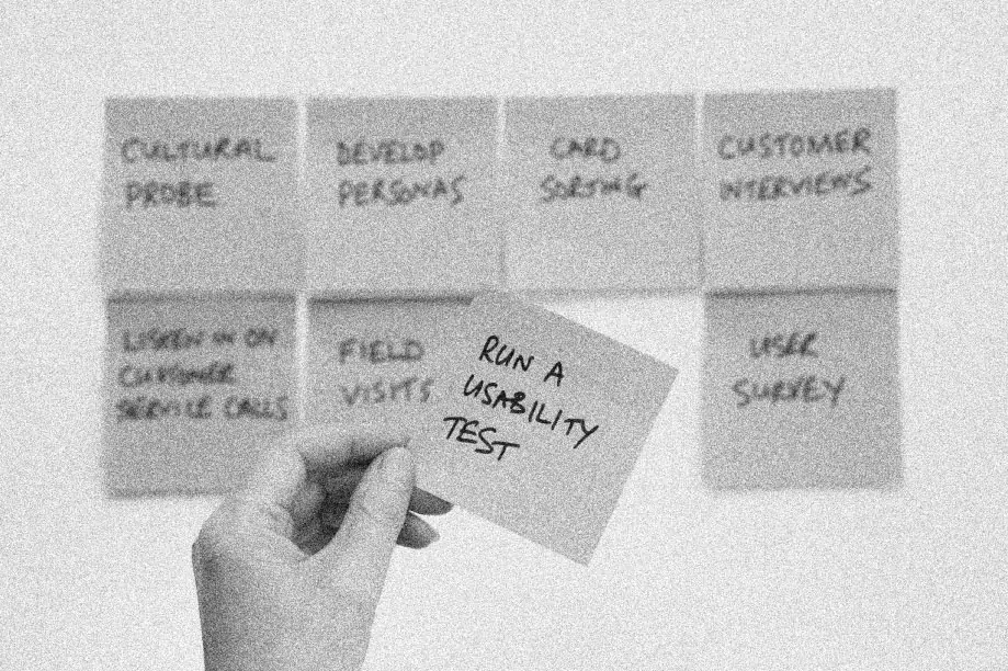 A person conceptualizing the functionality of a mobile app using sticky notes.